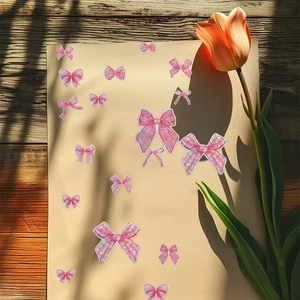 Détail d'autocollants nœuds laser roses avec paillettes sur un fond en bois texturé