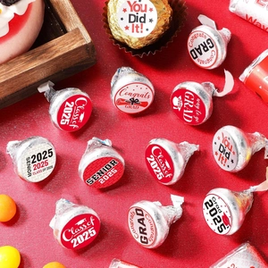 Close-up of Class of 2025 graduation stickers on chocolates with festive red background