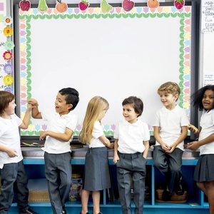 Classroom bulletin board with colorful fruit and flower border stickers for teachers