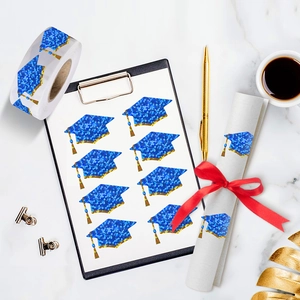 500pcs holographic graduation cap stickers roll with gold tassel on marble background