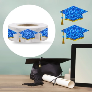 Detail of holographic blue graduation cap stickers on a roll for festive decoration