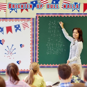 Classroom teacher decorating blackboard with US flag themed bulletin board border trim