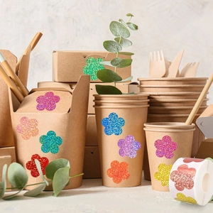 Glittering flower stickers on kraft coffee cups and gift bags for decorative packaging