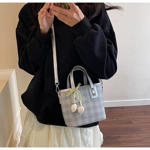 Silver checkered mini bucket bag with tulip charms and green ribbon bow details