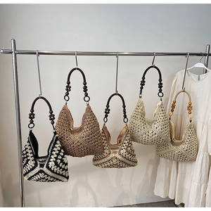 Detail of bohemian woven tote bags with wooden bead handles in various colors