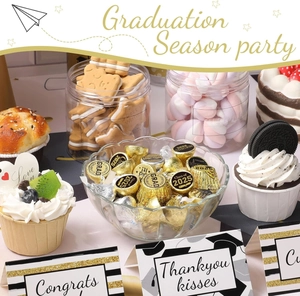 Close-up of Class of 2025 graduation stickers and black gold themed party table setup