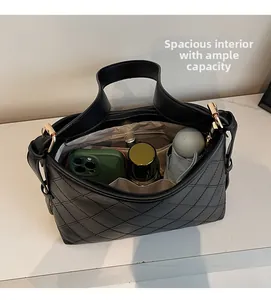 Spacious interior of black quilted tote bag showing daily essentials and golden clasp