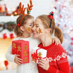 Gingerbread man glitter stickers for face and gift wrapping used in a festive setting
