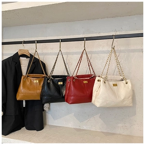 Detailed display of quilted chain tote bags in brown, black, red, and beige colors
