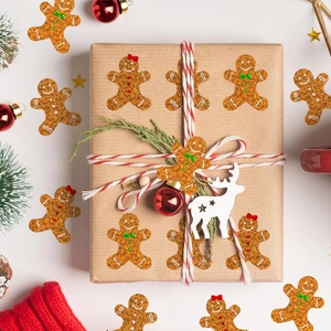 Macro detail of sparkly gingerbread man stickers applied on a kraft Christmas gift box