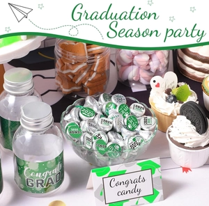 Detail of 2025 graduation party stickers on water bottles and dessert table decorations