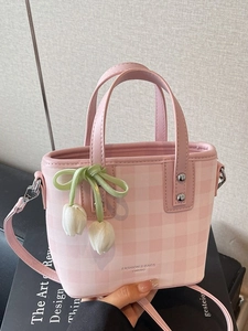 Pink checkered mini bucket bag with tulip pendant and adjustable shoulder strap