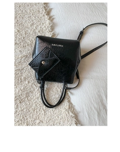 Detail of black glossy crinkled leather handbag with PANTOOR logo and matching mini pouch