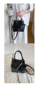 Detail of glossy pleated black leather bucket bag with matching mini coin purse accessory