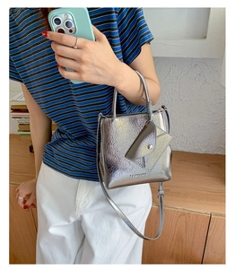 Detail of silver metallic tote bag with detachable mini pouch and crinkled PU texture