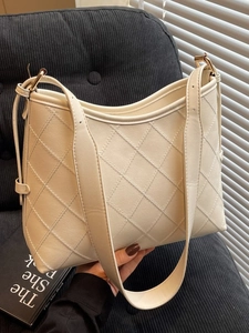 Elegant white quilted tote bag with diamond stitching and adjustable strap for women