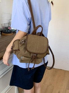 Vintage brown canvas backpack with leather straps and front flap for casual travel