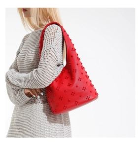 Close-up of red tote bag with unique 3D floral bead textures on lychee pattern leather