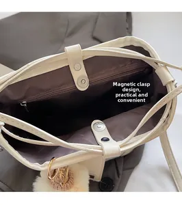 Detail of minimalist bucket bag interior with magnetic closure and inner zipper pocket