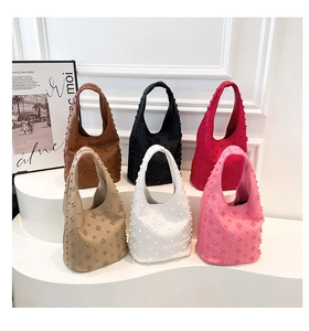 Detail shot of multi-color minimalist baguette bags with 3D rivet texture on white stands