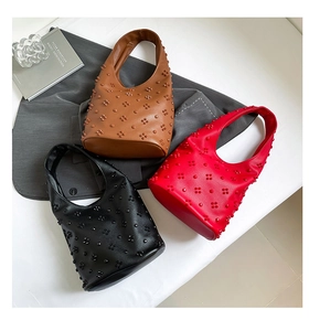 Detailed close-up of Hobo bags with 3D floral rivets in black, red and brown colors