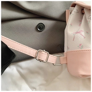 Detail of pink floral backpack showing adjustable shoulder strap with silver metal buckle