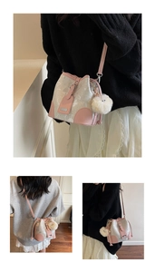 Detail of drawstring bucket bag with pink and marble texture and plush pompom charm