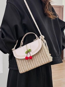 Handmade woven straw box bag with white leather flap and decorative cherry charms