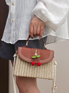 Woven straw box bag with cotton fringe, cherry ornaments and brown leather flap