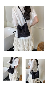 Detail of black bow shoulder bag featuring delicate pearl embellishments on soft fabric