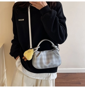 Silver checkered handbag featuring a cute yellow chick plush charm and silver handles