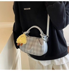 Silver-grey checkered crossbody bag with yellow chick pendant and adjustable strap