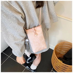 Detailed view of pink floral jacquard mini bag with drawstring and grey tassel detail