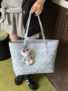 Light blue woven tote bag for women with quilted texture and cute plush bear charm