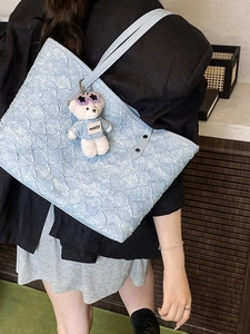 Light blue woven bubble tote bag for women with a cute plush bear pendant accessory