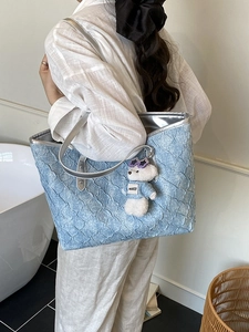 Blue textured woven tote bag for women with silver straps and a cute bear charm