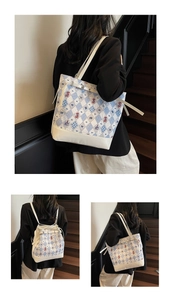 Detail of blue diamond pattern tote bag showing the cartoon bear print and versatile straps