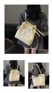 Detail of striped bucket bag with cat illustration and adjustable multi-way straps