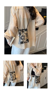 Detail of embroidered floral phone bag with decorative tassel and slim shoulder strap
