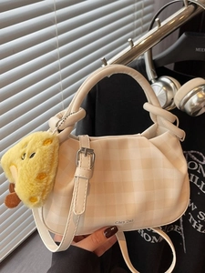 Cream pleated checkered boston handbag with crossbody strap and cheese plush charm