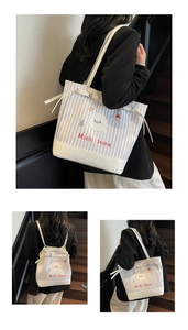 Detail showing blue striped canvas tote bag with seal print and reinforced white base