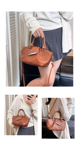 Detail of brown lychee grain leather bucket bag with silver horn buckle and knotted handle