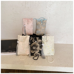 Detailed view of Chinese style mini crossbody bags with floral embroidery and pearl clasps