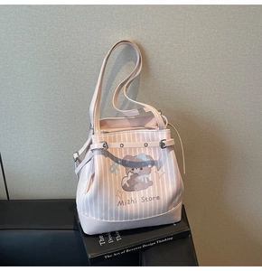 Detail of light pink striped tote bag with cute bear print and silver buckles