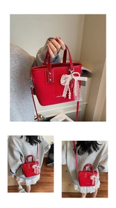 Detail of red faux leather bucket bag with lace bow, pearls, and adjustable shoulder strap