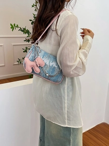 Chic blue woven underarm bag for women with pink trim, silver chains and dog charm detail