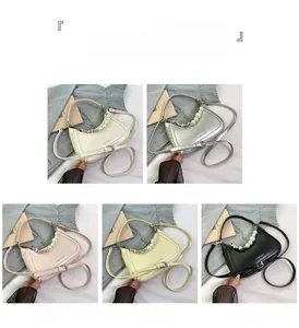 Detail view of half-moon underarm bags with pearl chains in five elegant colors
