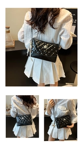 Detail of black quilted crossbody bag with sparkling star charms and silver metal chain