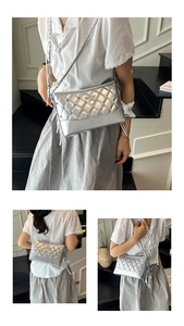 Detail view of silver quilted crossbody bag with star charms and chain strap on a model