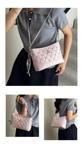 Detail of pink quilted shoulder bag with silver star rhinestones and chain strap